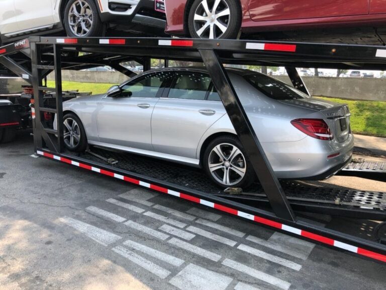 silver mercedes on open trailer
