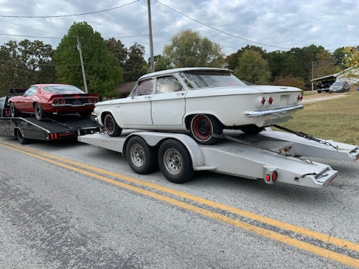 white classic bmw on open trailer