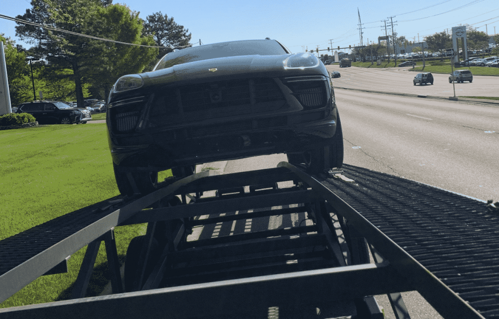 Porsche cayenne SUV shipping front view, on a open trailer ready to be shipped from VA to PA