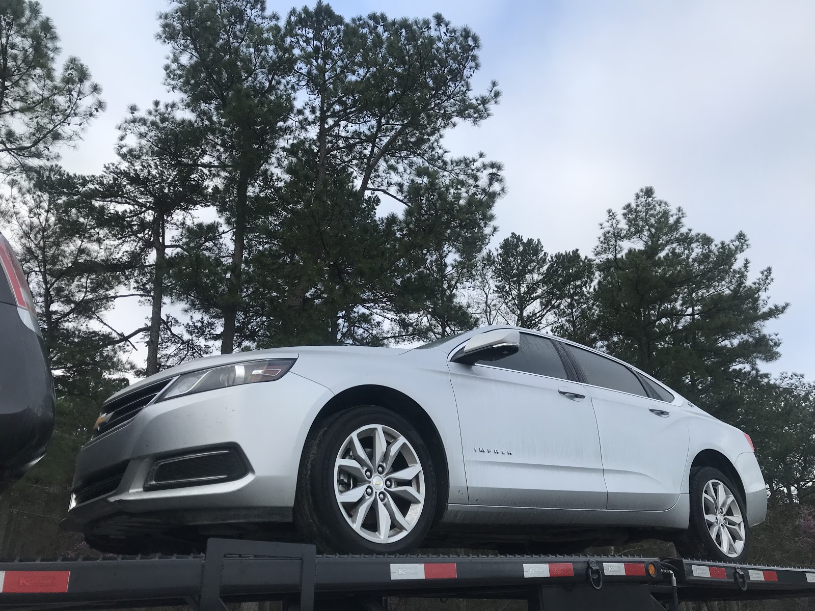 chevy impala on open trailer