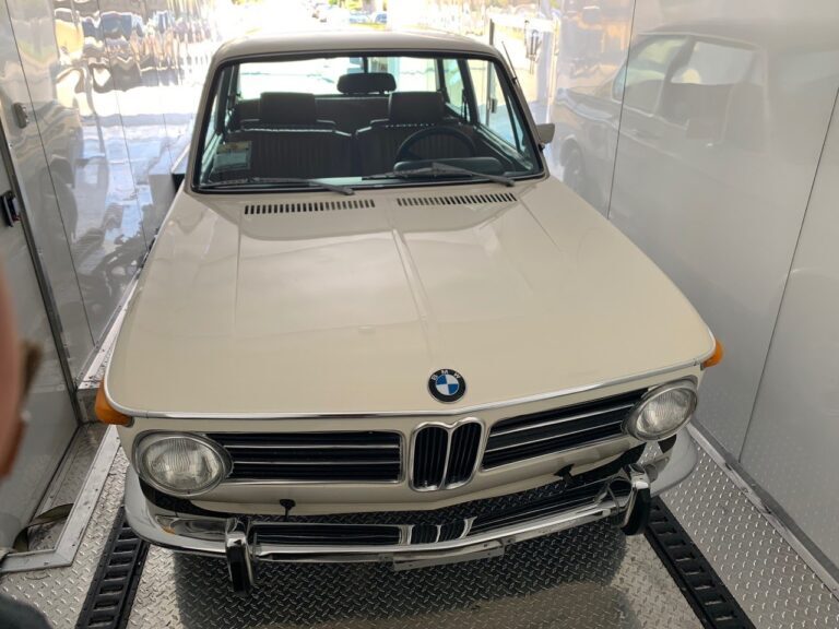 white classic bmw in enclosed trailer