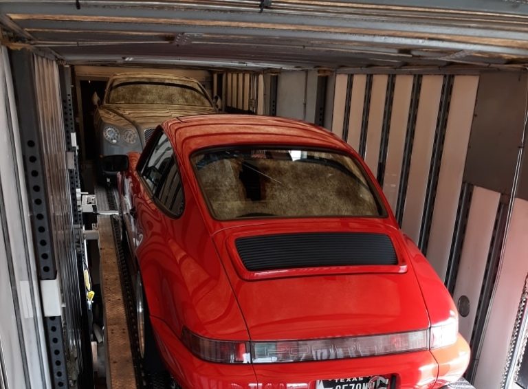 red porsche in enclosed trailer for auto transport