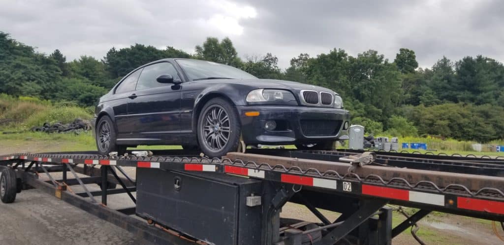 dark blue bmw on trailer for auto transport