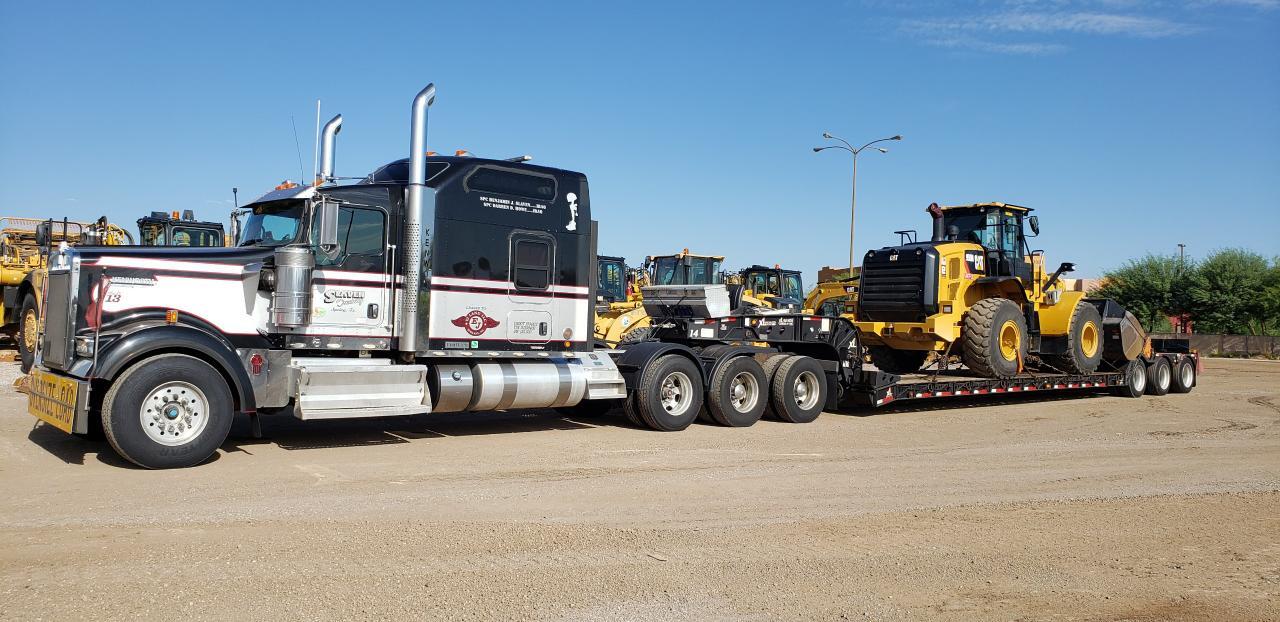 Semi-truck transporting heavy machinery