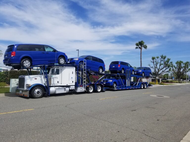 multiple mobility vans on open trailer