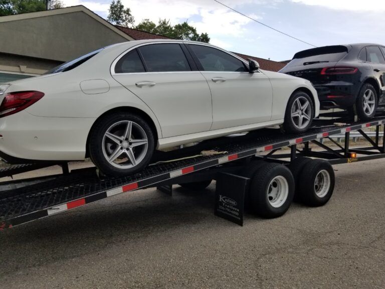white mercedes on open trailer