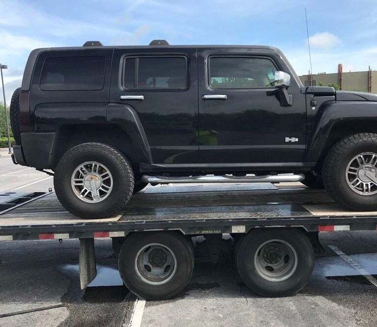 black Hummer H3 on flatbed