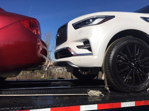 2020 infiniti QX80 SUV with another car on trailer