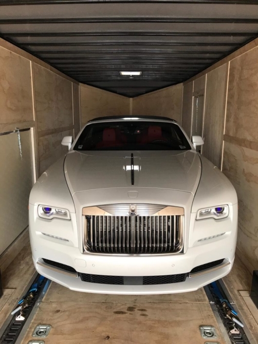 white rolls royce in enclosed trailer for auto transport