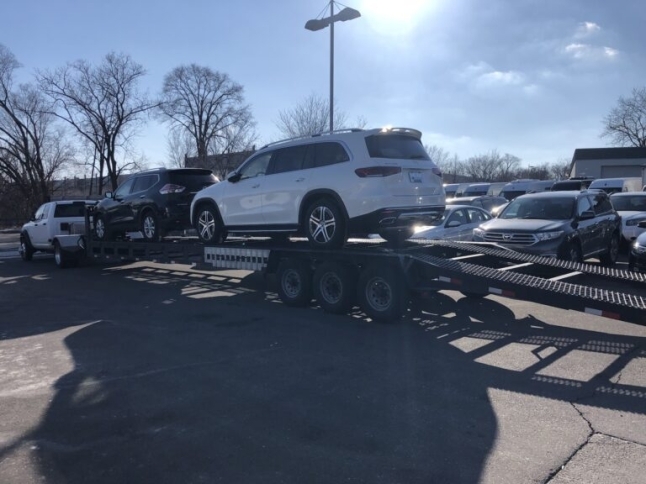 white mercedes on open trailer