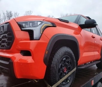 Open car shipping service with vehicles loaded on an auto transport carrier