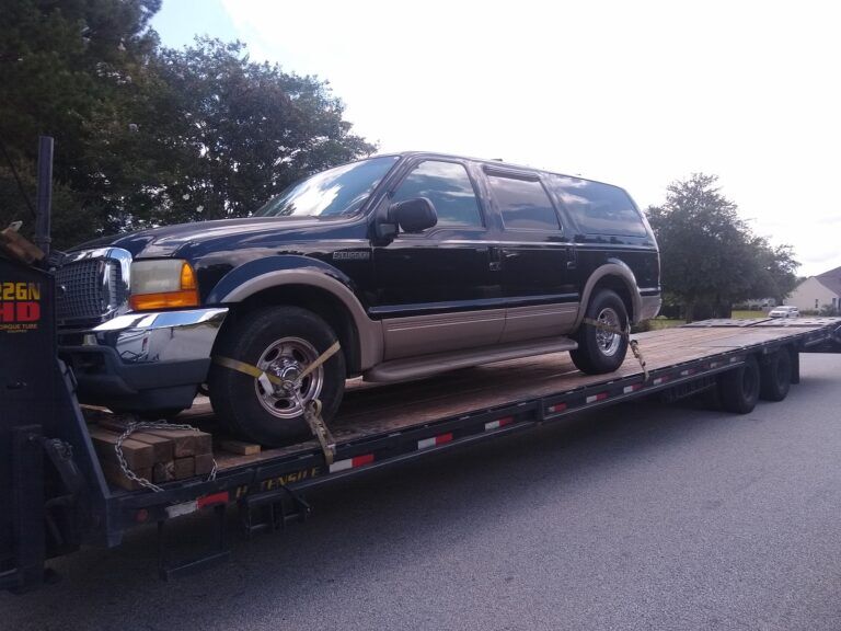 ford excursion on flatbed trailer