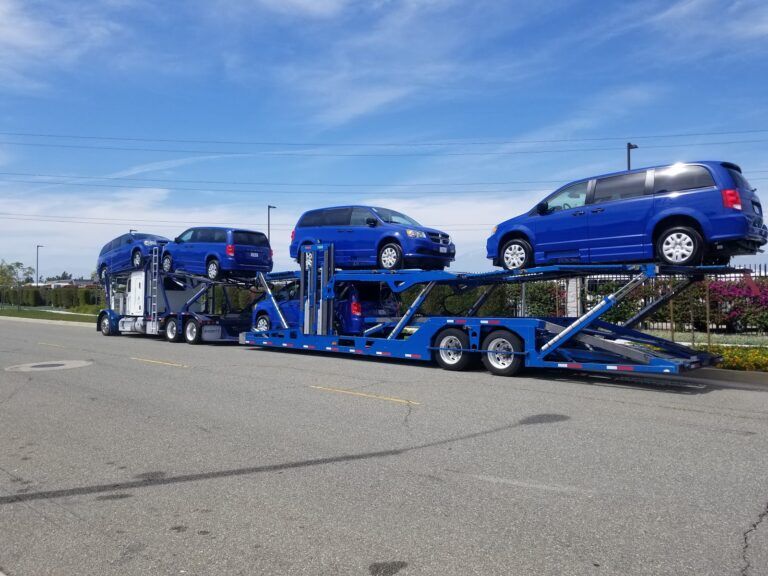 multiple mobility vans on open trailer
