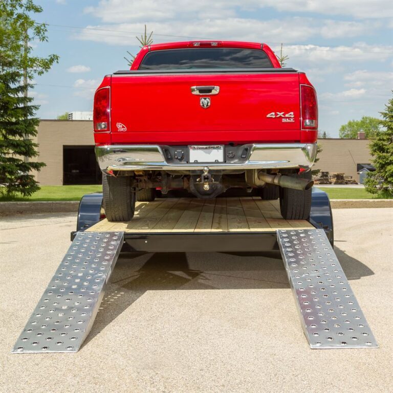 red dodge truck on ramps for car shipping