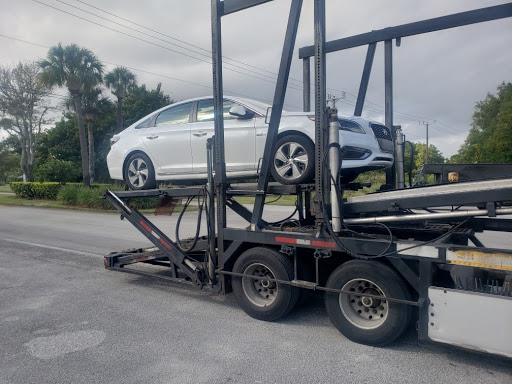 white hyundai on open trailer