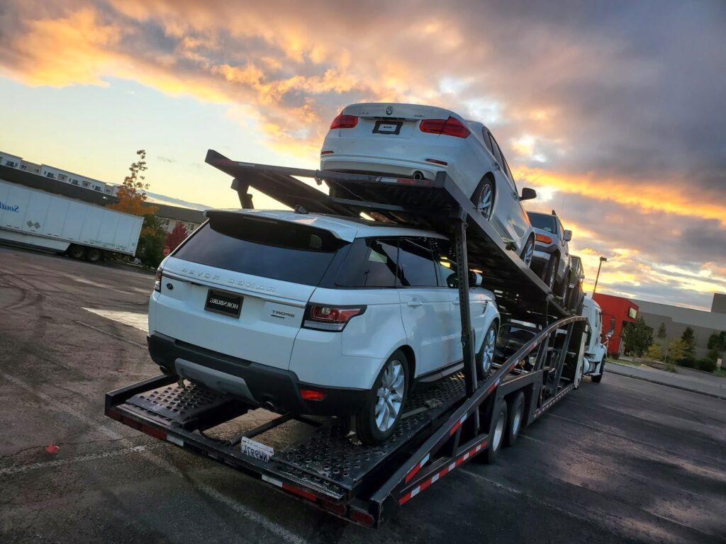 multiple vehicles on open trailer