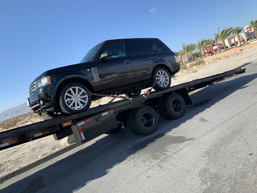 black land rover on open trailer