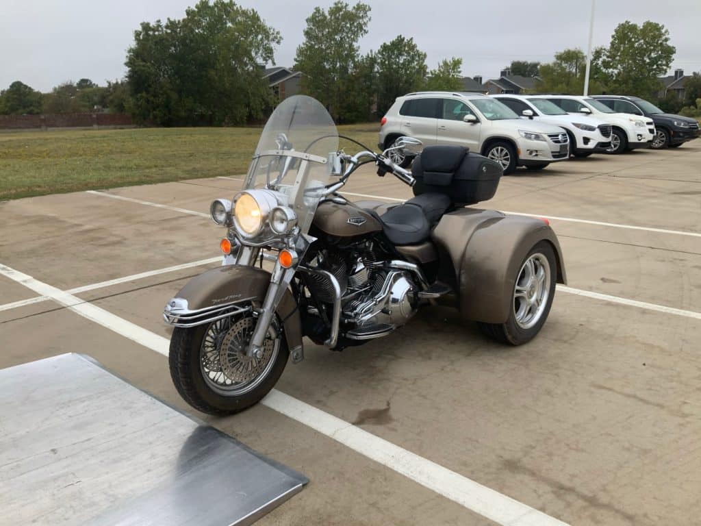 tri-wheel motorcycle being loaded onto trailer for wyoming driveaway services