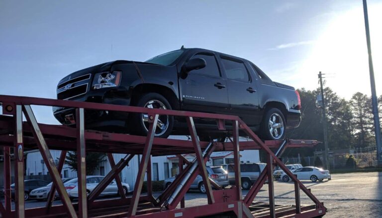 Chevrolet Avalanche being transported by our trailers