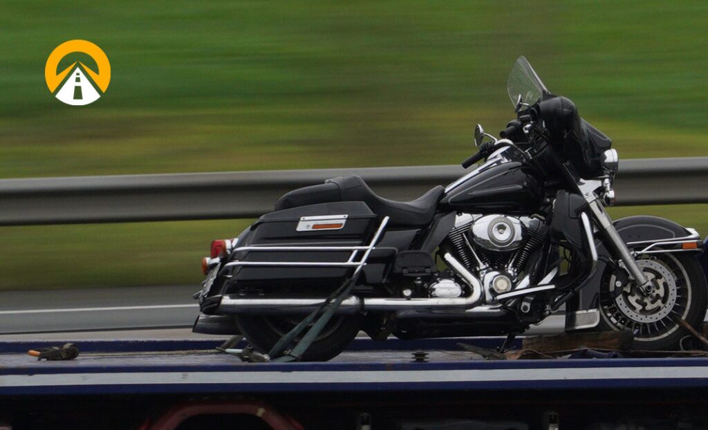 motorcycle being shipped on trailer with AT logo watermark