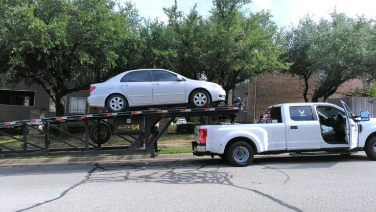 silver camery toyota on trailer for auto transport