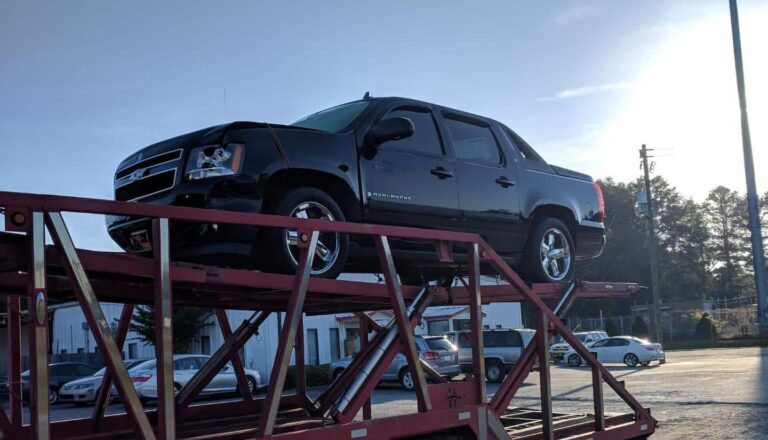 Chevrolet Avalanche being transported by our trailers