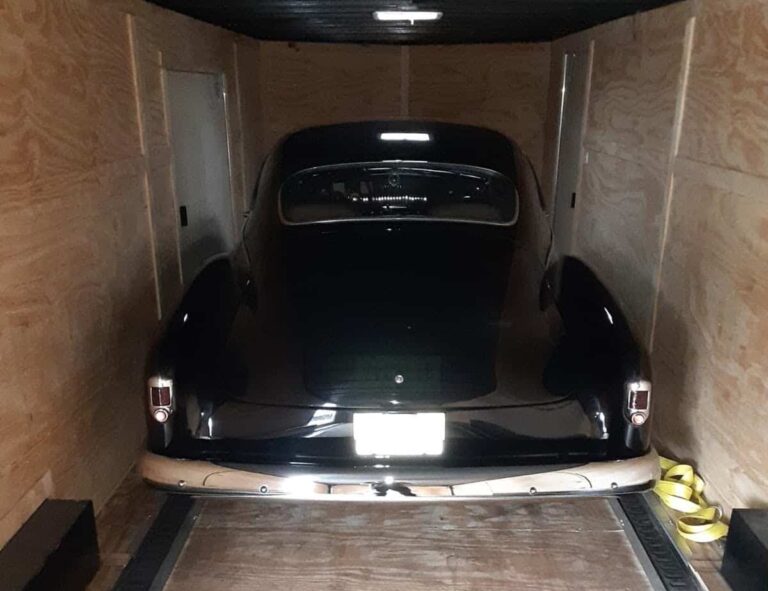 Chevy classic back view in closed trailer