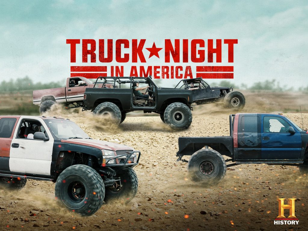 Four trucks on a dirt track in the TV show Truck Night in America on History channel.
