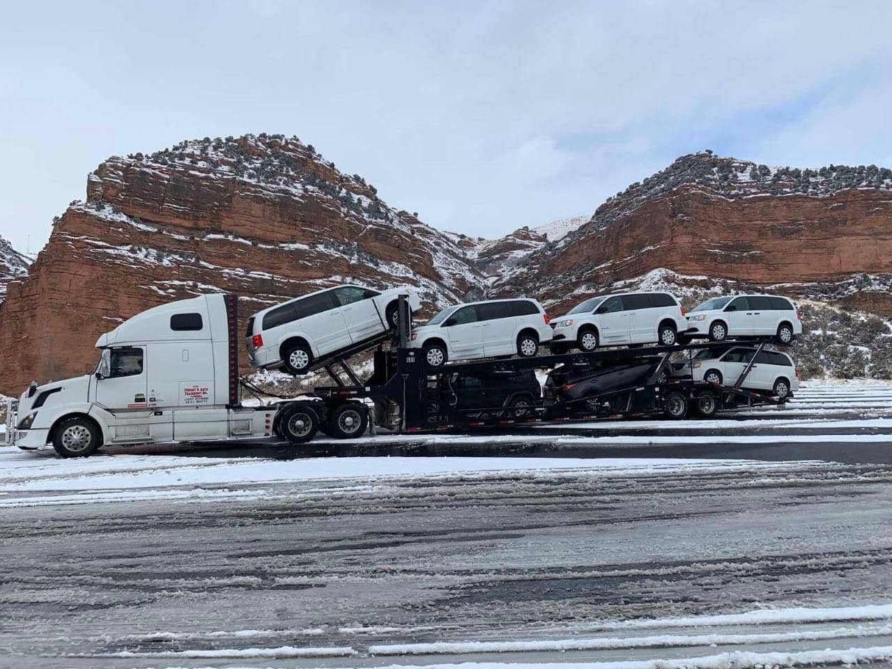 Montana car transport, shipping multiple mobility vans on open trailer in Montana