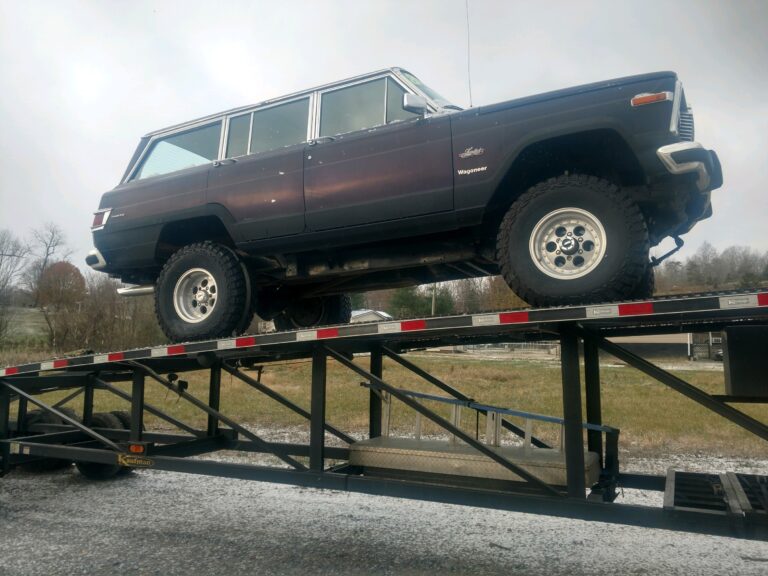 jeep wagoneer on open trailer