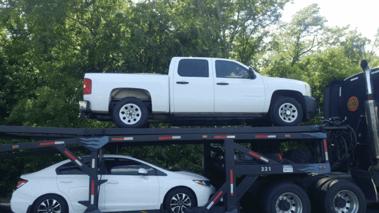 white chevy truck on open trailer