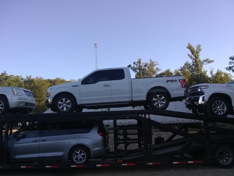 white ford truck on open trailer