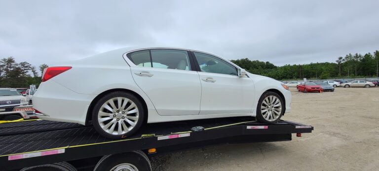 white acura on trailer