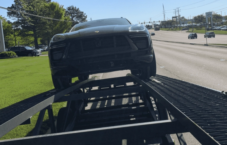 Porsche cayenne SUV shipping front view, on a open trailer ready to be shipped from VA to PA