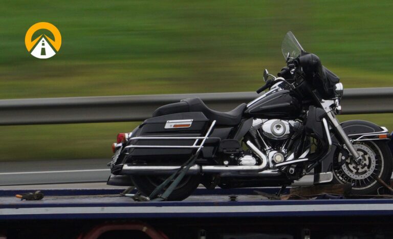 motorcycle being shipped on trailer with AT logo watermark