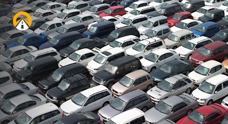Various cars parked closely together in a large outdoor lot.