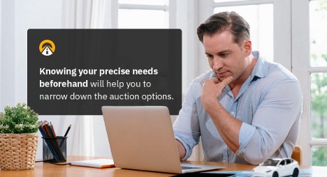 Man sitting in front of a laptop, appearing thoughtful, with text about knowing your needs before choosing auction options.