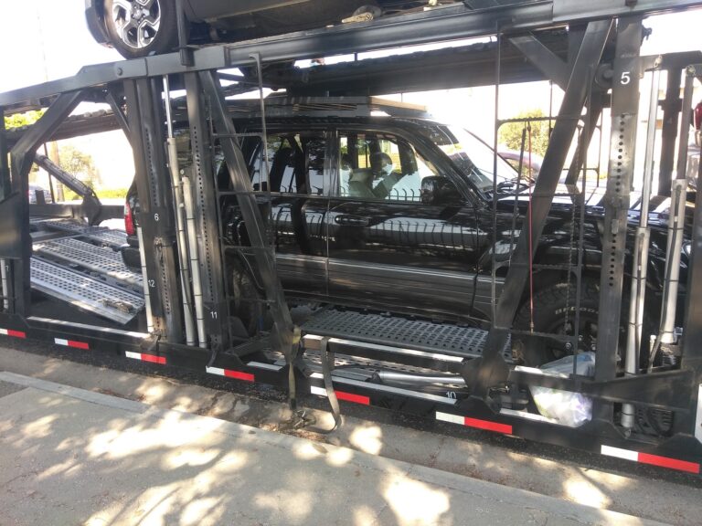 black vehicle on open trailer