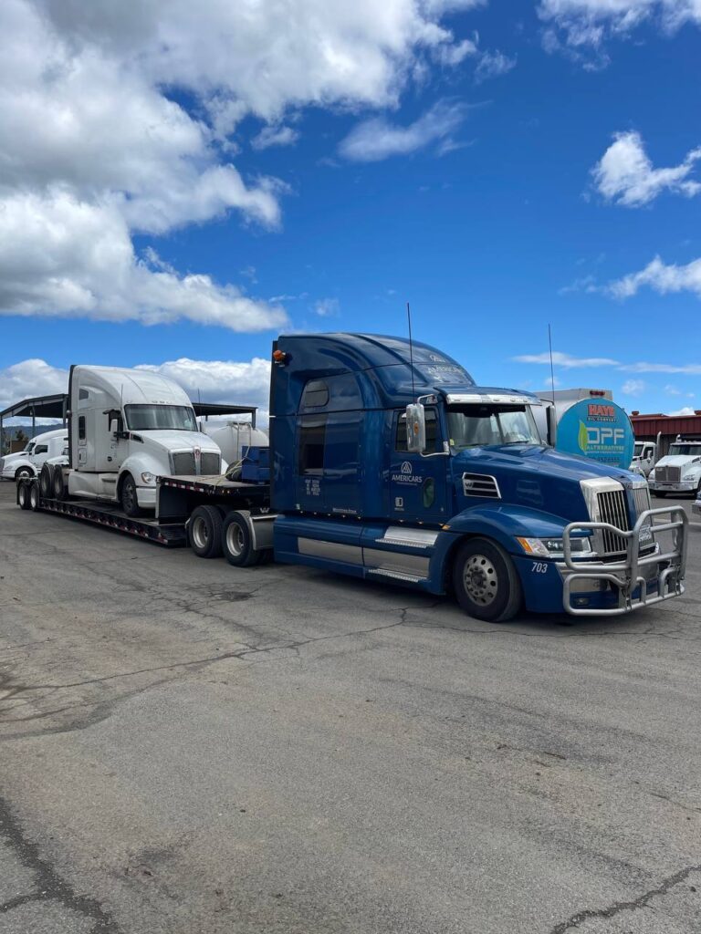 blue semi hauling white semi
