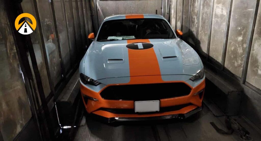Ford Mustang in Gulf livery inside a car carrier.