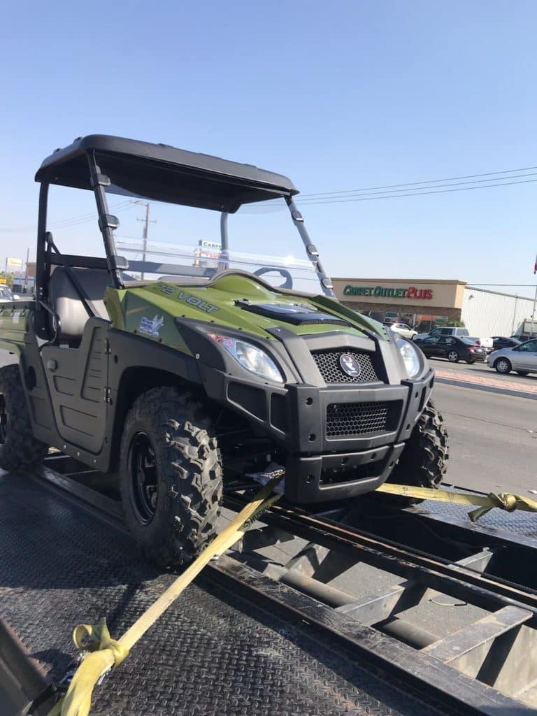 Green John Deere Gator transport by our Kentucky driveaway services