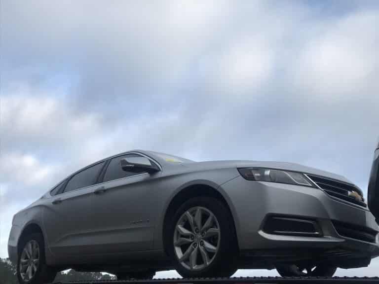 chevy impala on open trailer