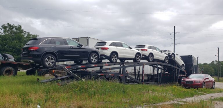 multiple mercedes cars on open trailer
