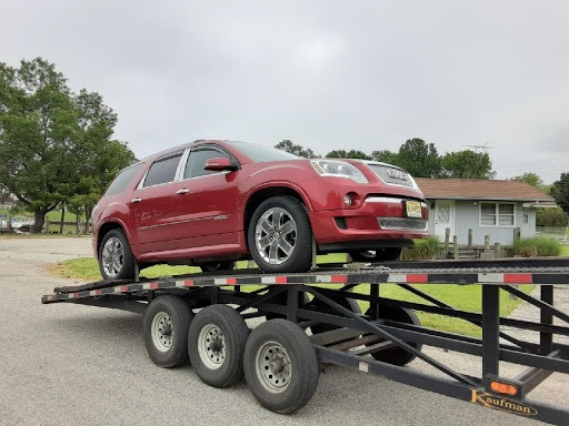 red gmc acadia on open trailer