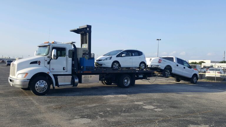 honda fit and ford truck on tow truck trailer