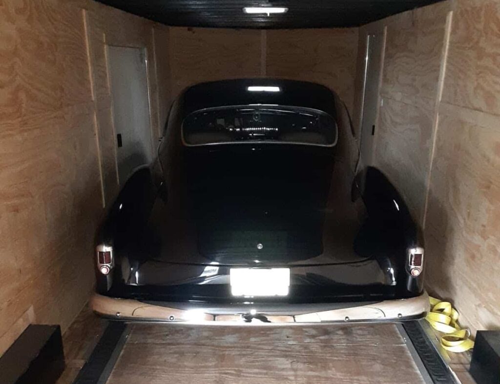 Chevy classic back view in closed trailer