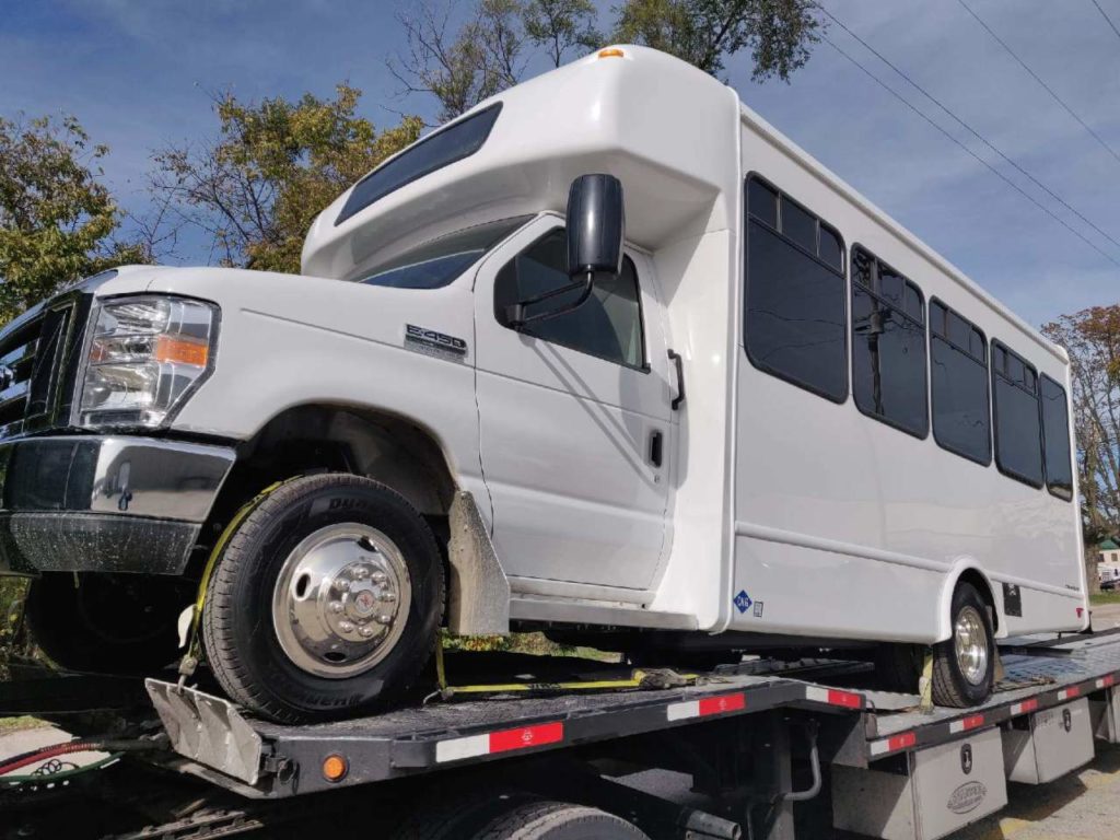 White van on open trailer transported on better dates