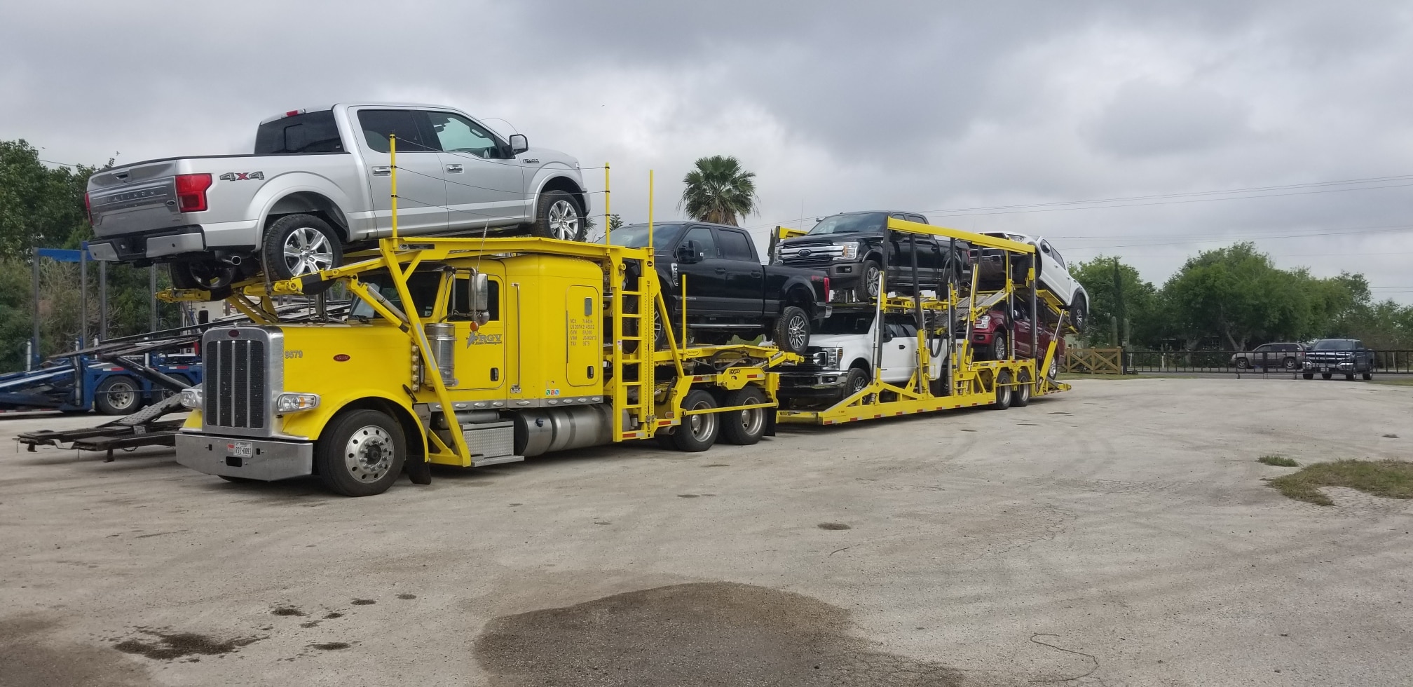 7 Ford 150s on oversize transport vehicle