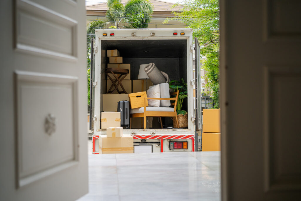 house moving services with boxes packed in a box truck outside of the front door