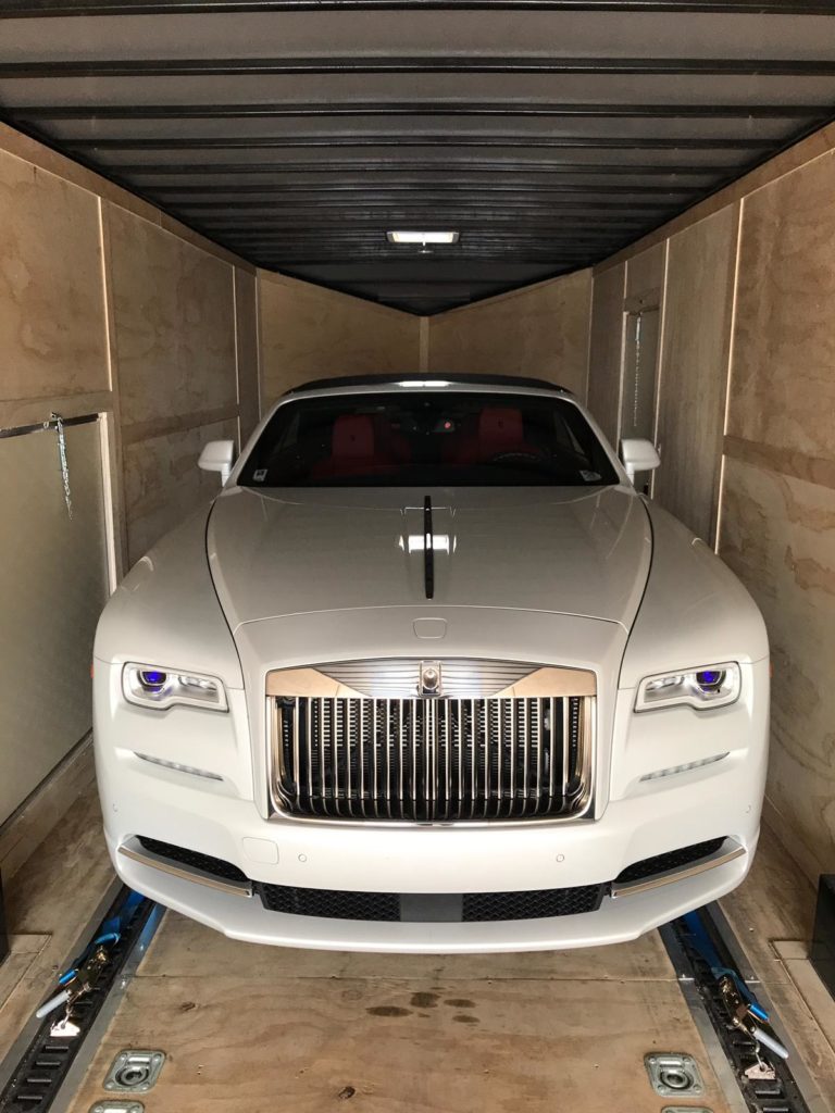 white rolls royce in enclosed trailer for auto transport